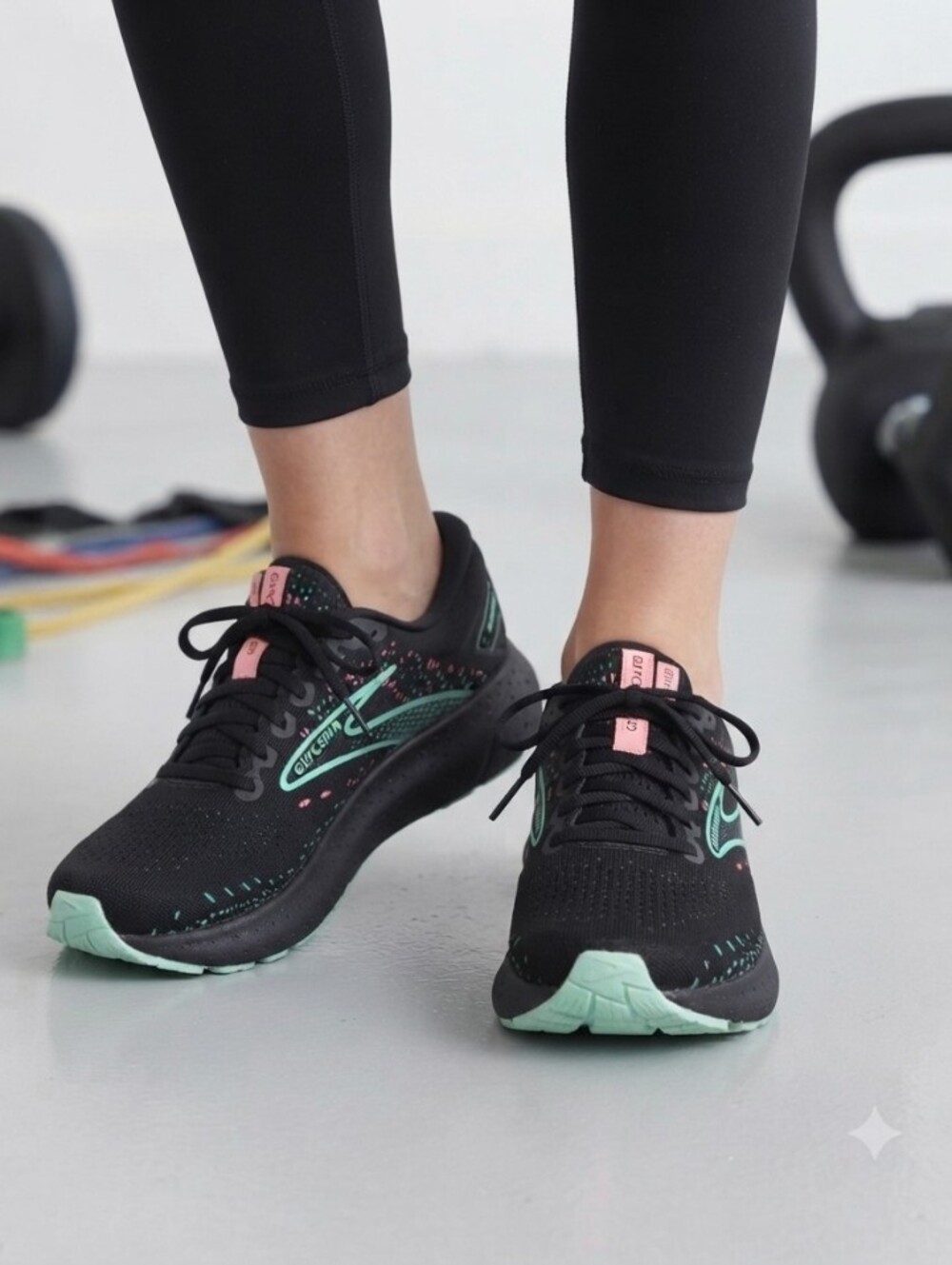 Brooks Black Running Shoes with Mint and Pink Accents Small detail visible in th
